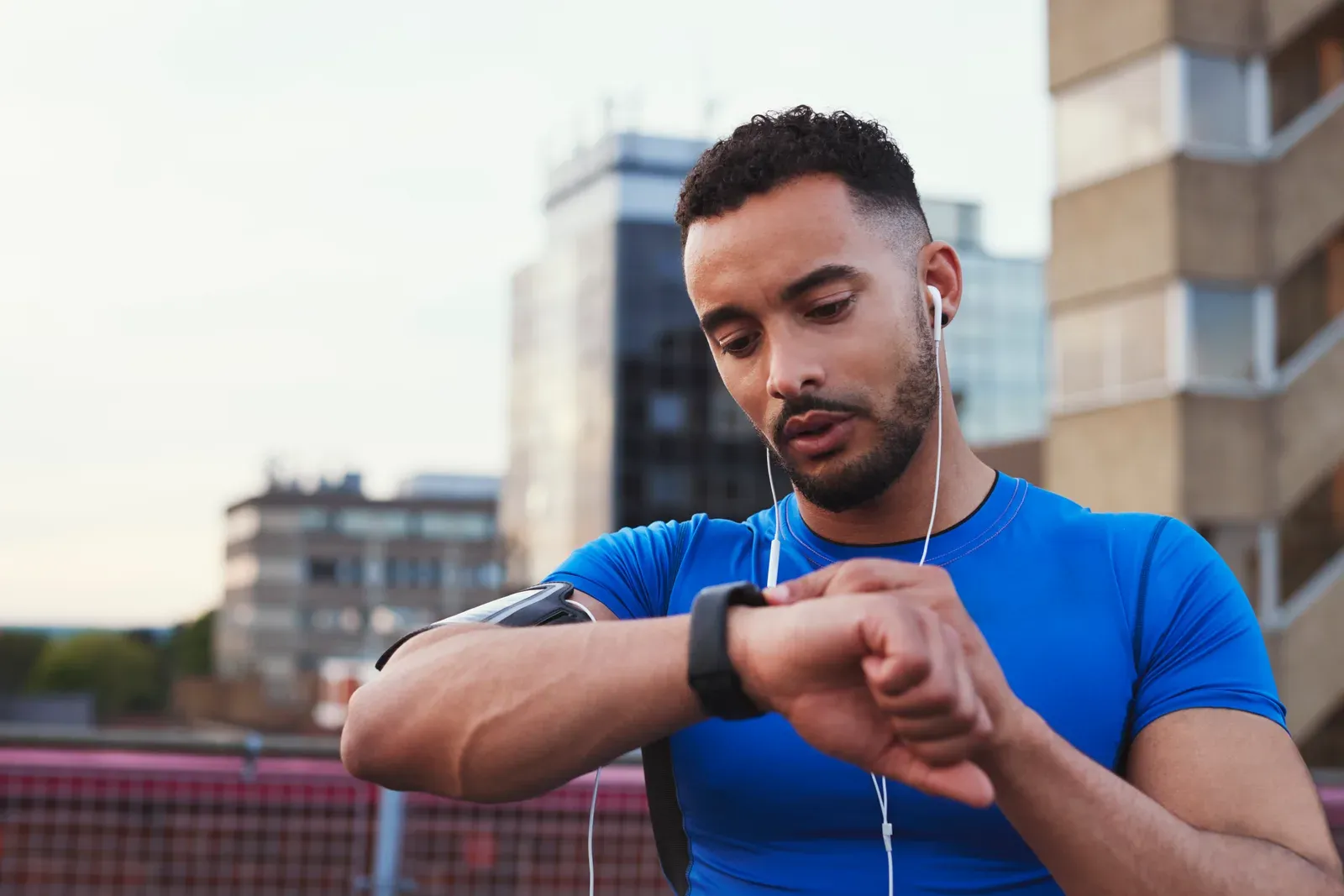 Mid run check of a smartwatch fitness app on a city street
