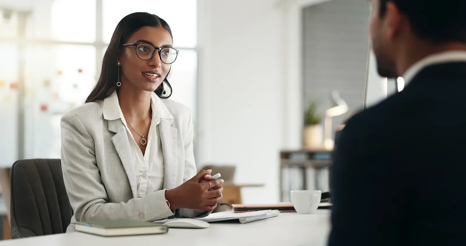 Business people in a meeting with a conversation across a table, like asking an employer about training