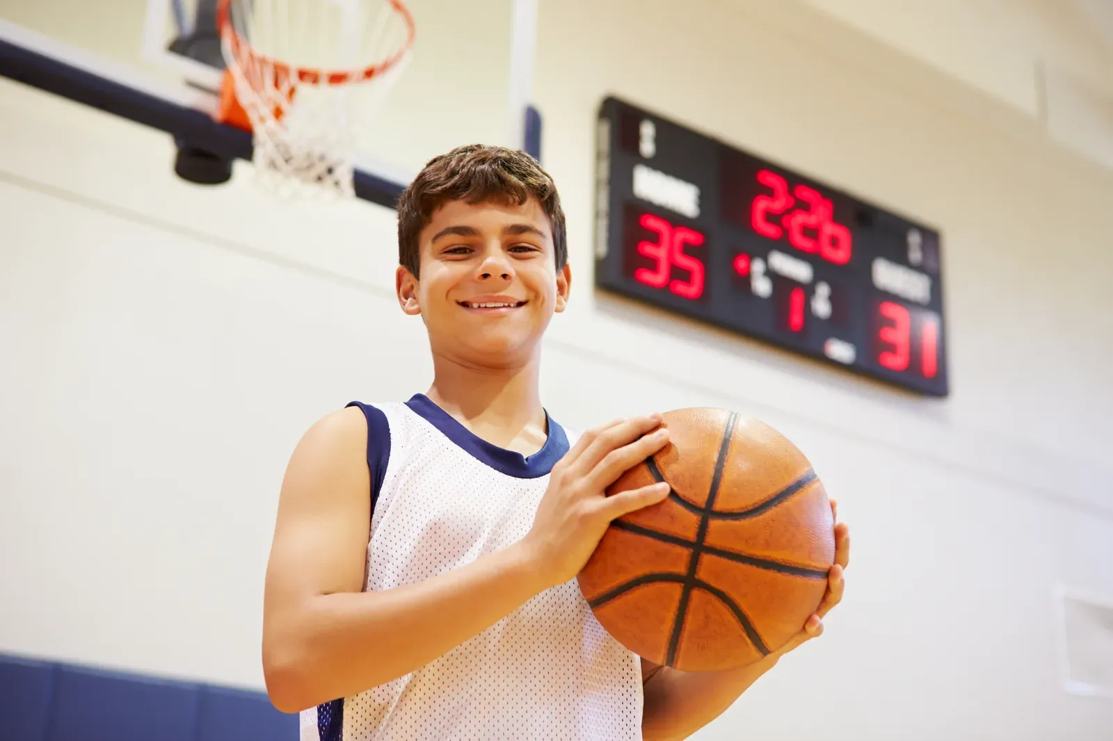 Basketball player rising for a rebound during an indoor training session