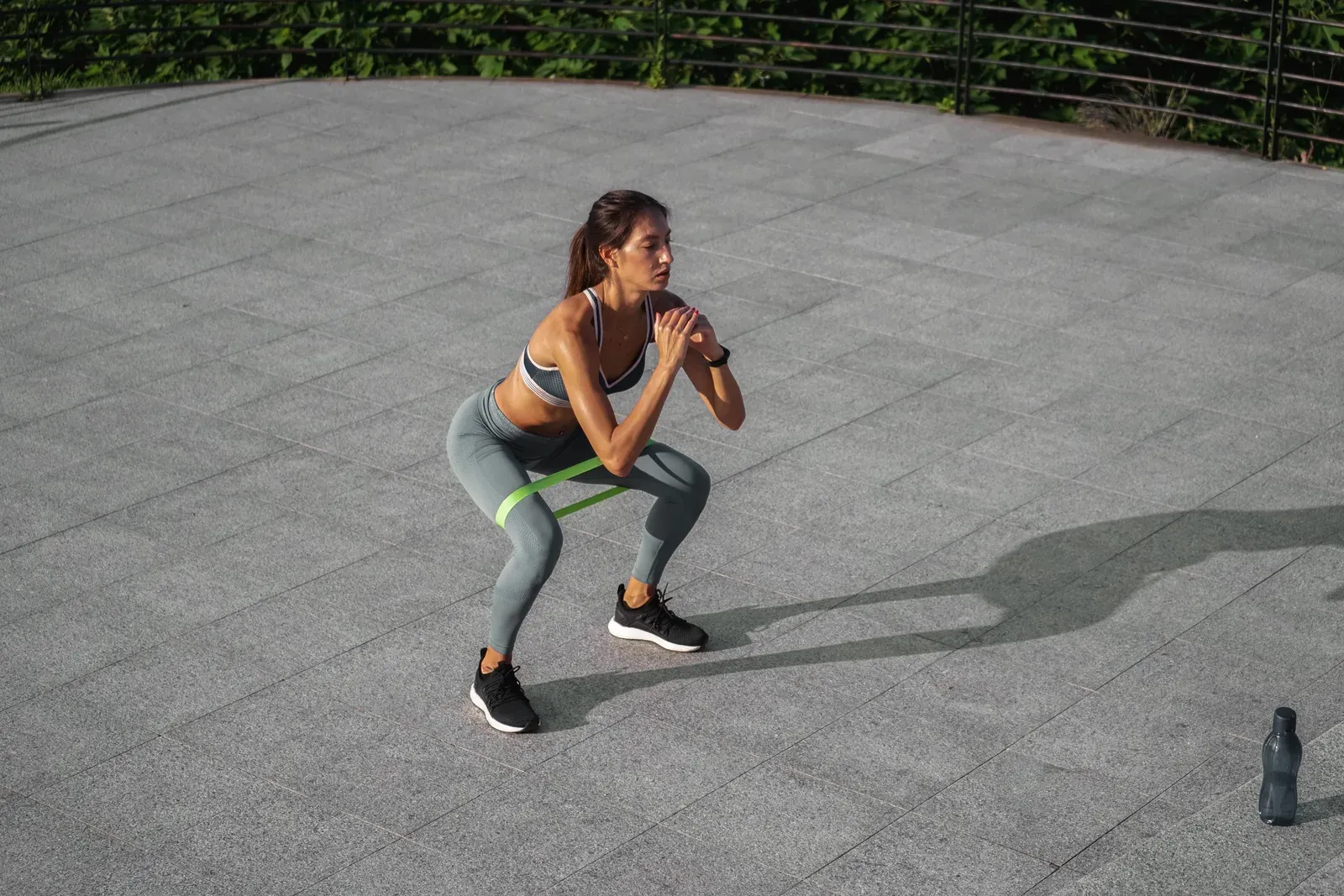 Young woman working out outdoors with an exercise band, accessible movement that may help with anxiety
