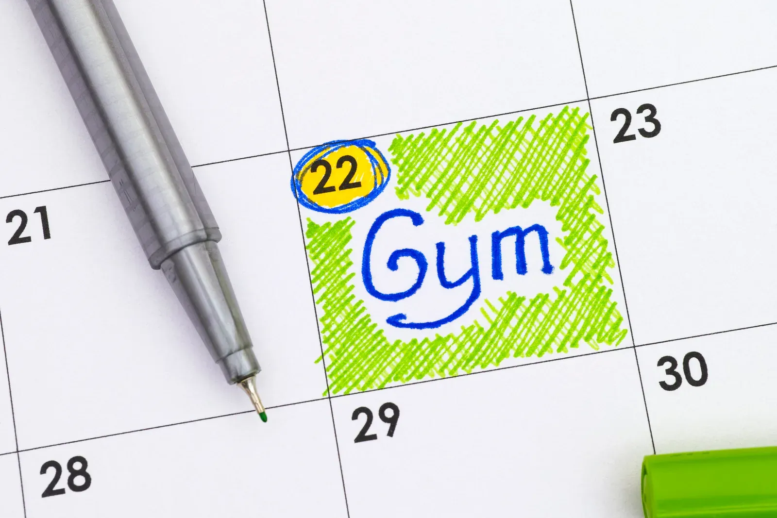Gym reminder written in a calendar with a green pen, picking the best time of year to join