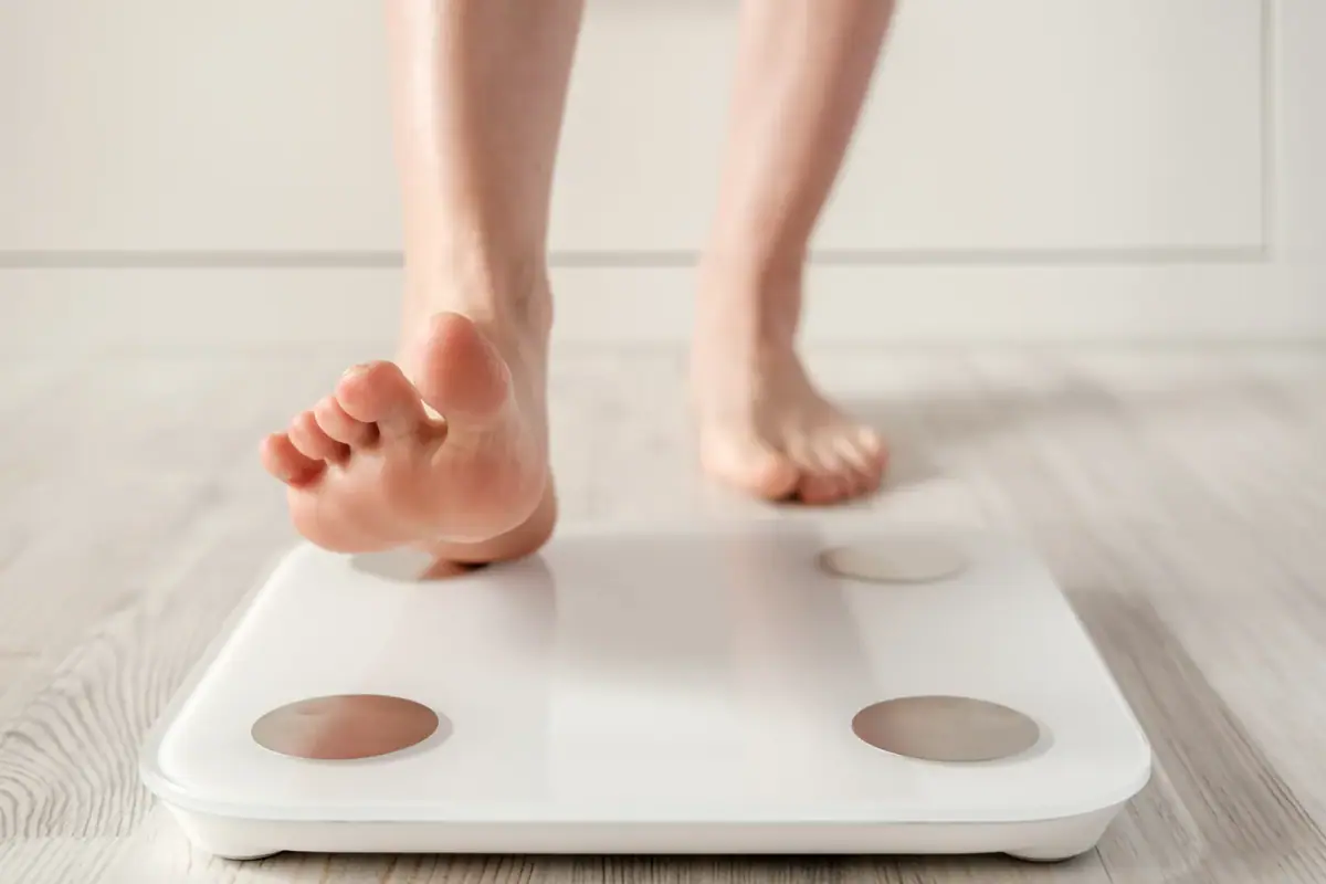 Two people going over a printed body composition analysis together at a table