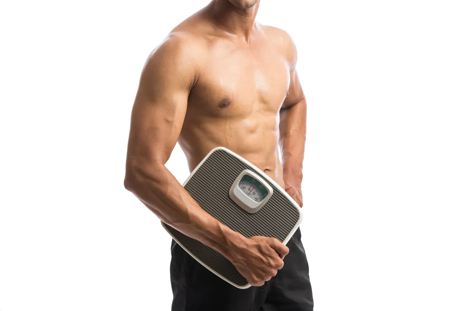 Fit young man holding a weighing scale, a simple tool next to body fat percentage and BMI comparisons