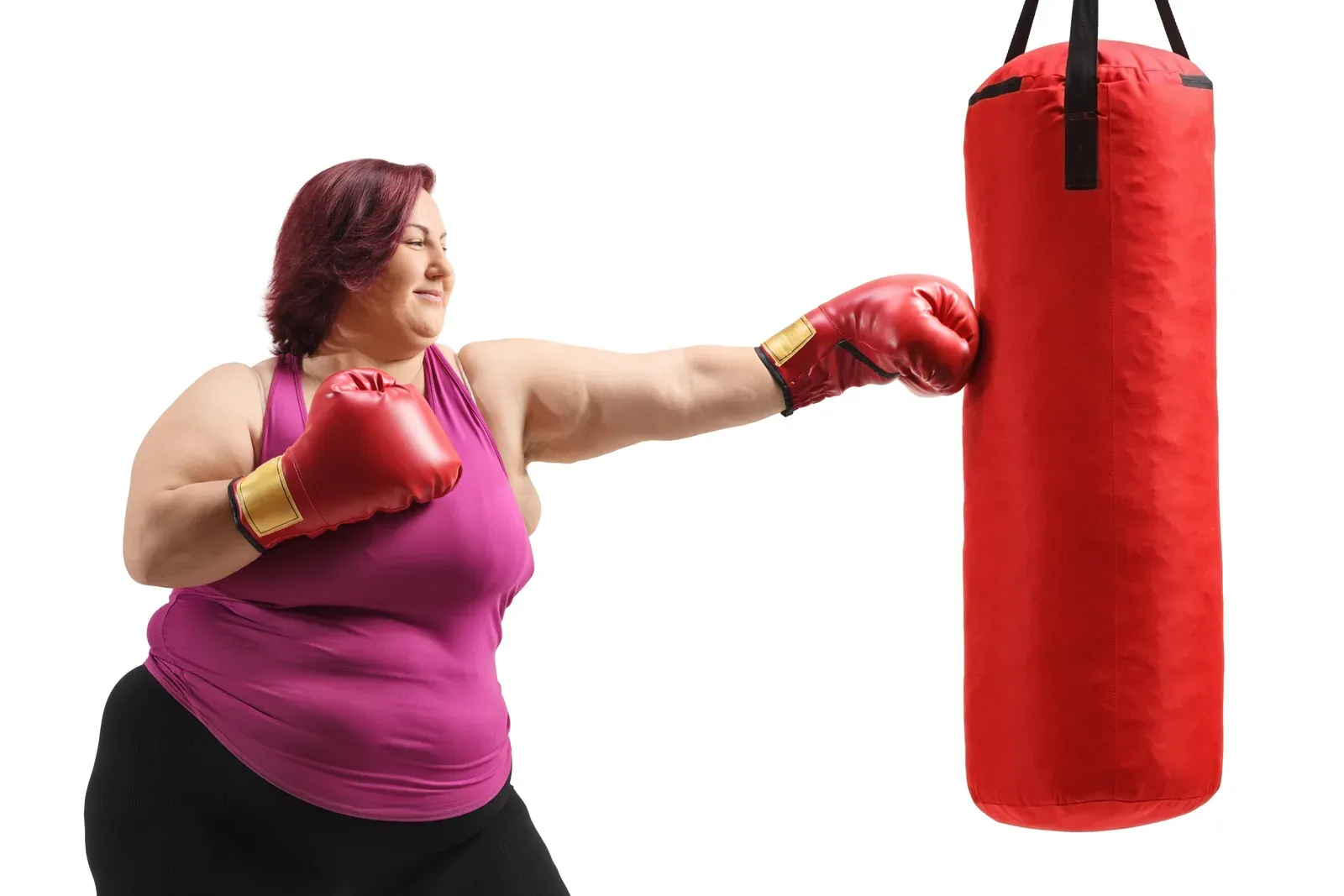 Woman training with a punching bag, a boxing workout often chosen for its calorie burn