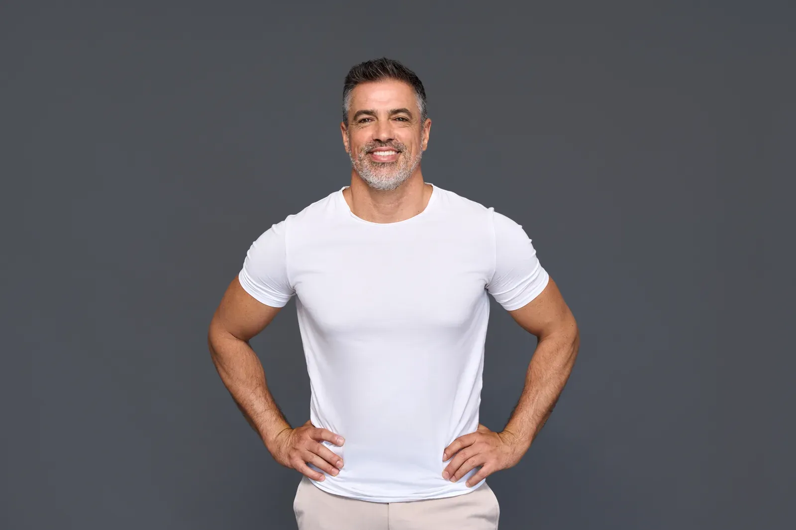 Fit mature man in a white t-shirt, proof you can build muscle after 50