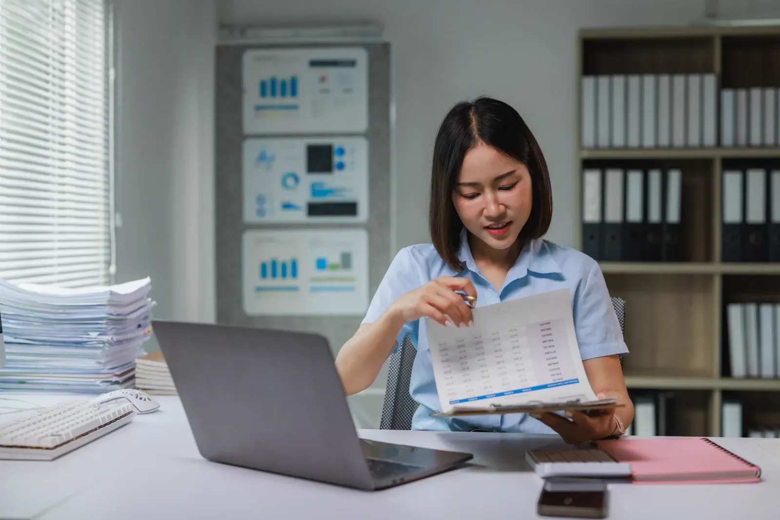 Businesswoman analyzing financial data during an online meeting, as when planning a corporate wellness budget