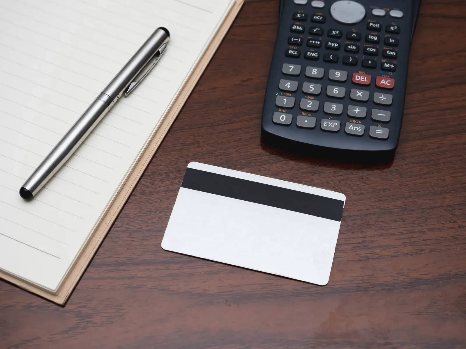 Credit card with a calculator on a table, a simple way to work out the cost per gym visit