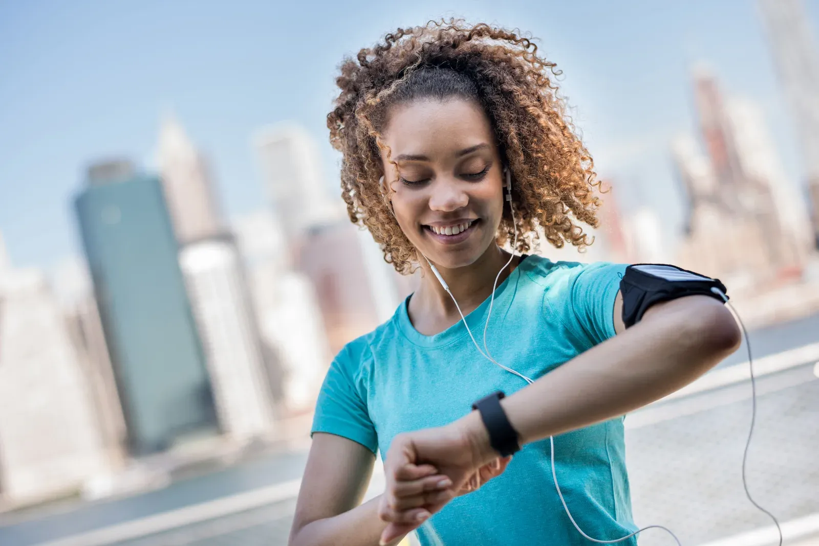 Sporty woman tracking her workout progress, a habit that helps when testing cycle syncing