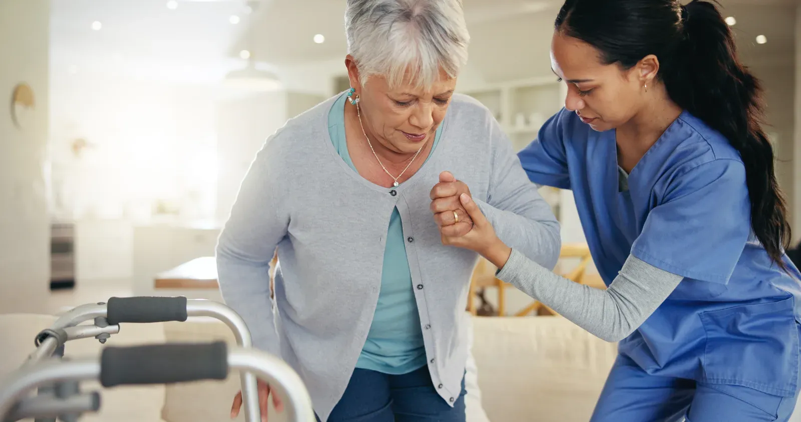 An older adult holding a rail while practicing a supported balance exercise