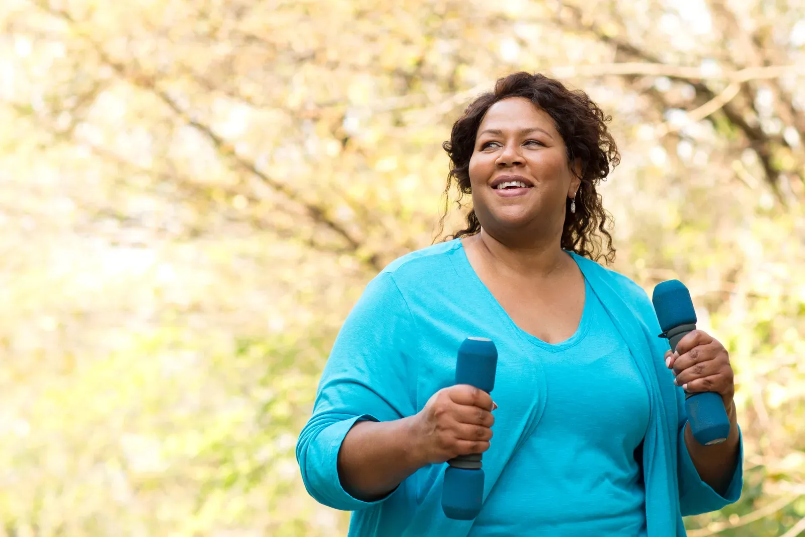 Mature woman smiling and exercising, a hopeful picture of getting strong again after a hip fracture