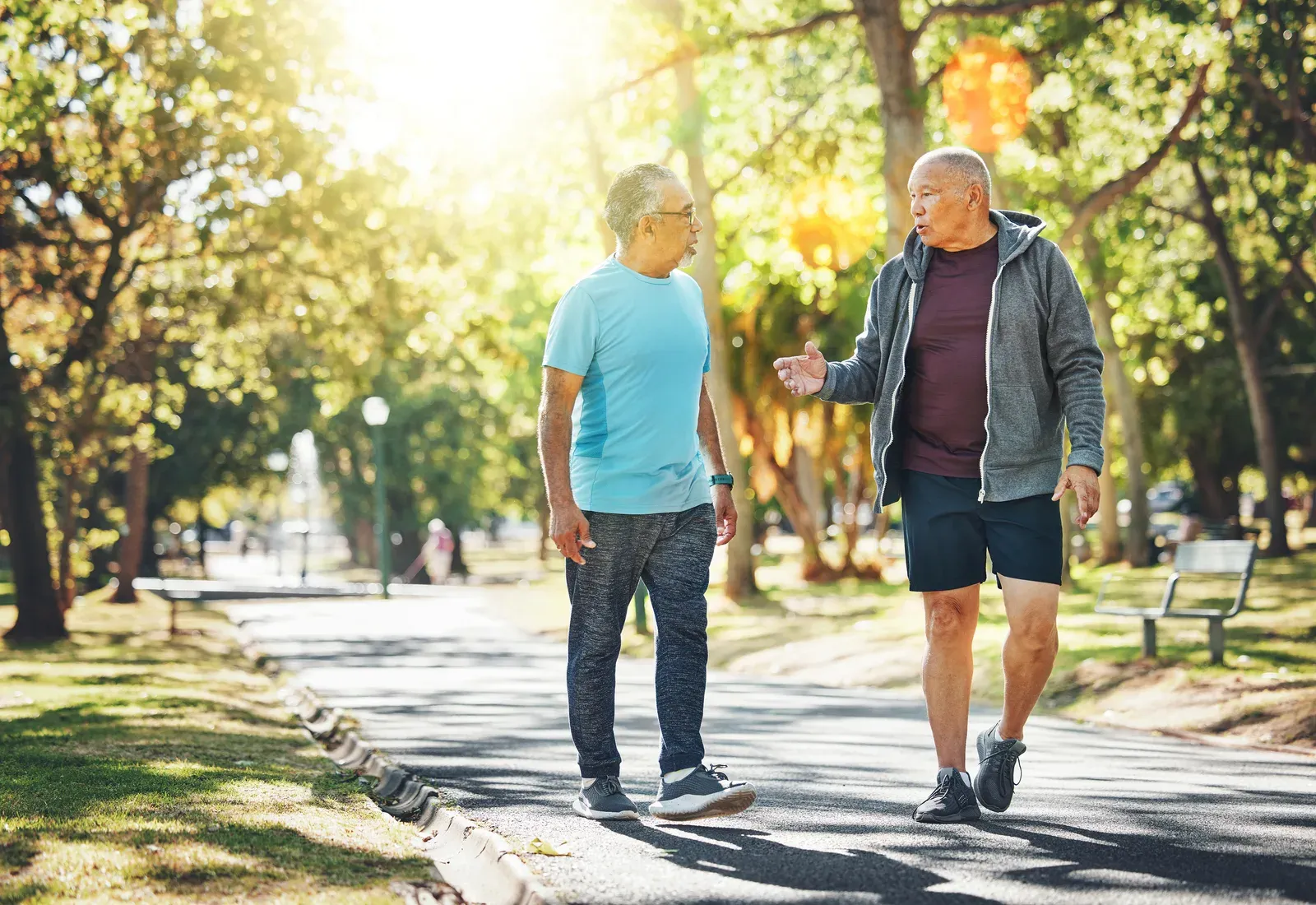 Senior men walking and chatting in a park, an easy social way to stay active and support wellbeing