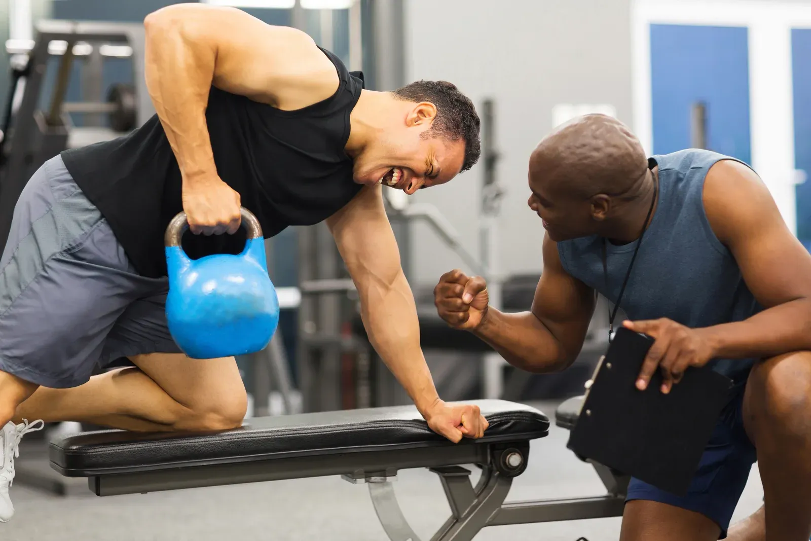 Personal trainer training a man with a kettlebell, supported strength work when planning exercise off a GLP-1