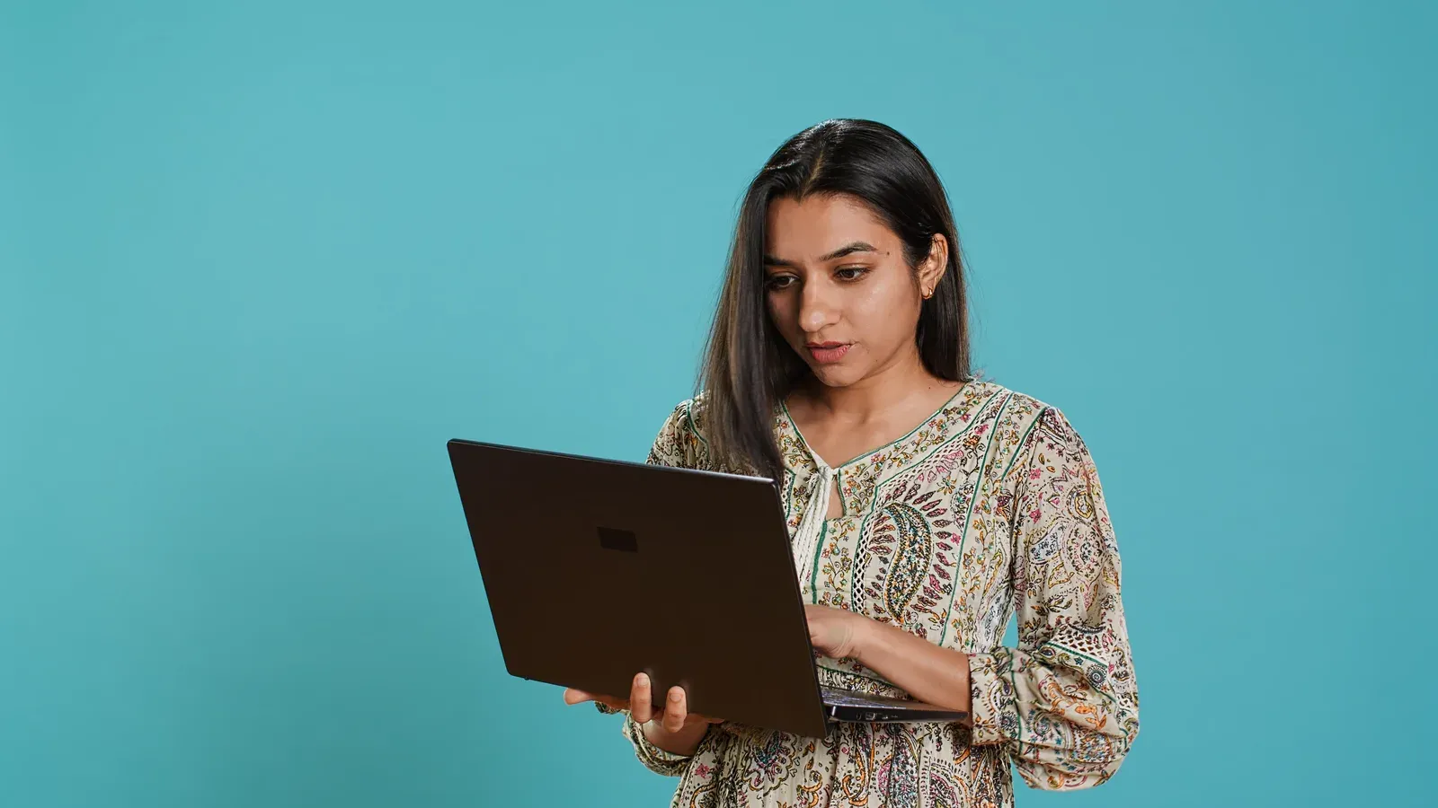 Woman typing an email on a laptop, as when writing up a complaint about a gym or trainer