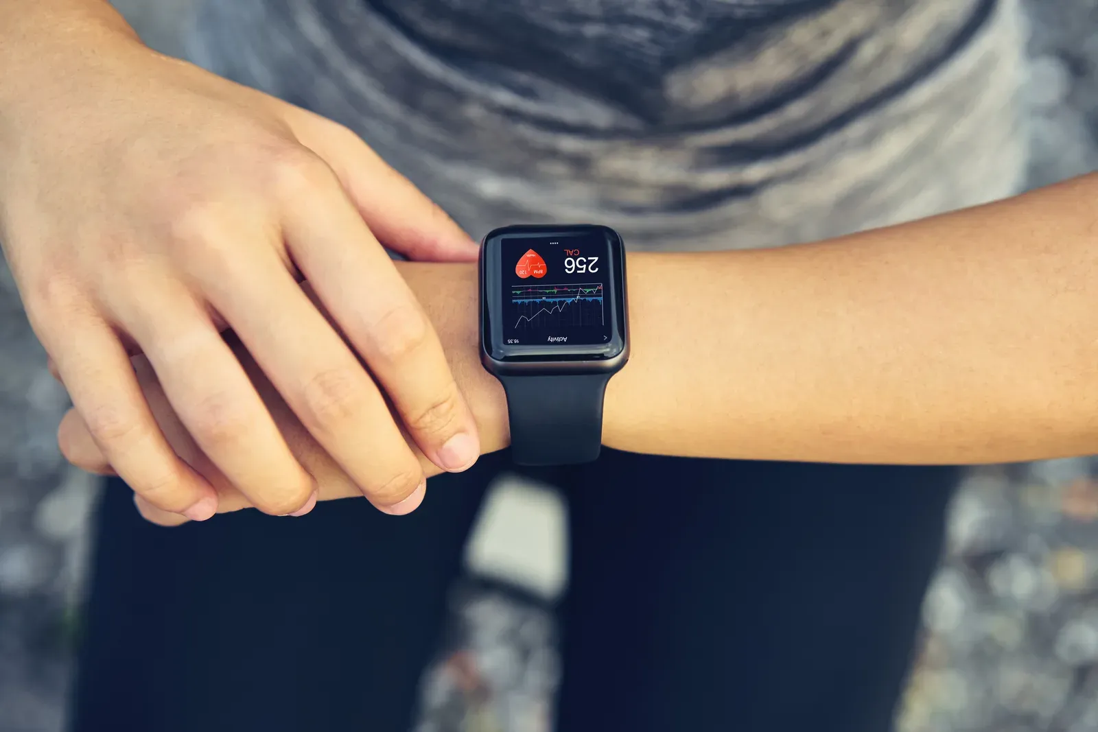 Young woman checking her sports watch for heart rate and performance after running, useful for finding zone 2