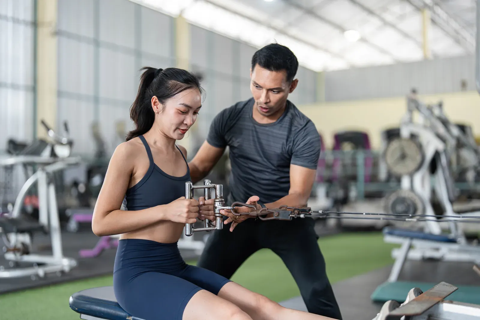 Trainer greeting a client arriving for a scheduled gym session