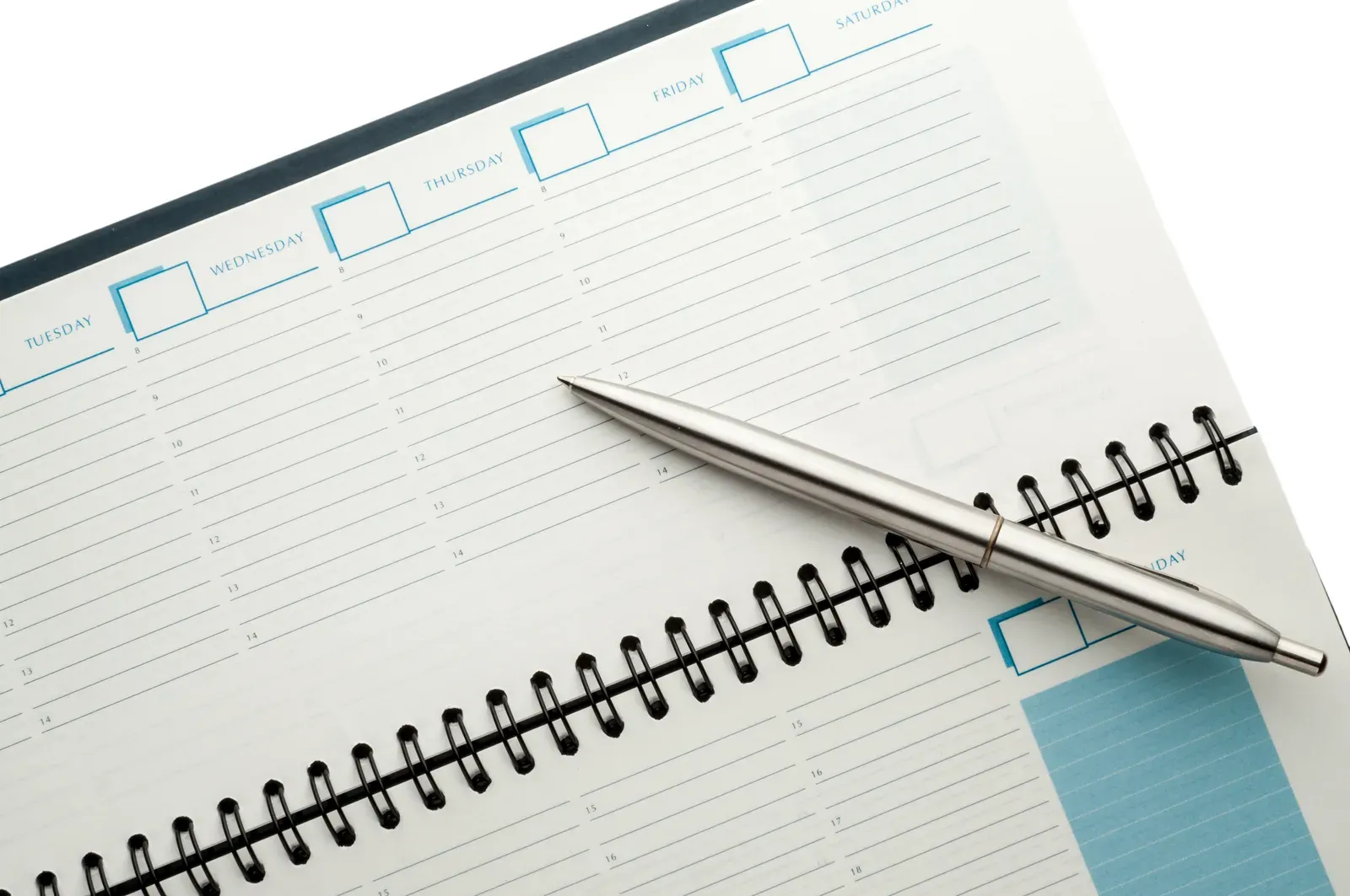 Open weekly planner with a ballpen, the tool behind choosing a fixed or flexible training schedule