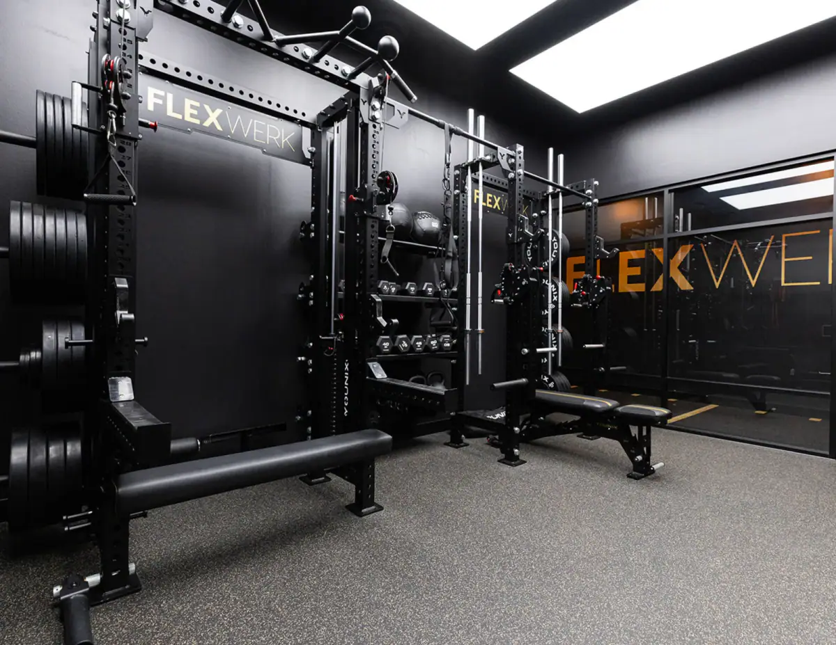 Racks, barbells, and equipment inside a FlexSpace Plus suite at FlexWerk Carmel