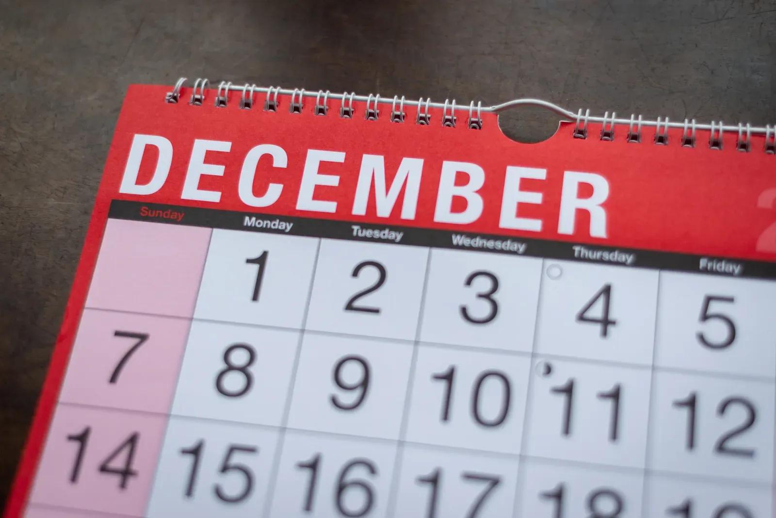 Close-up of a monthly wall and desk planner for December, marking the year-end deadline for an FSA balance
