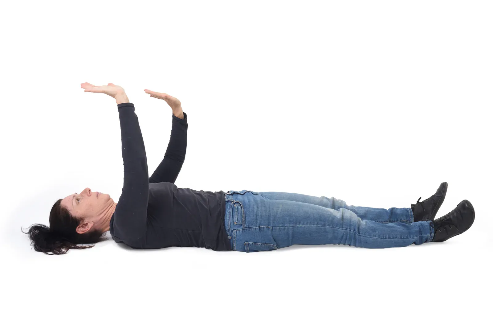 Woman lying on the floor pushing upward with her arms, a step in getting up from the floor