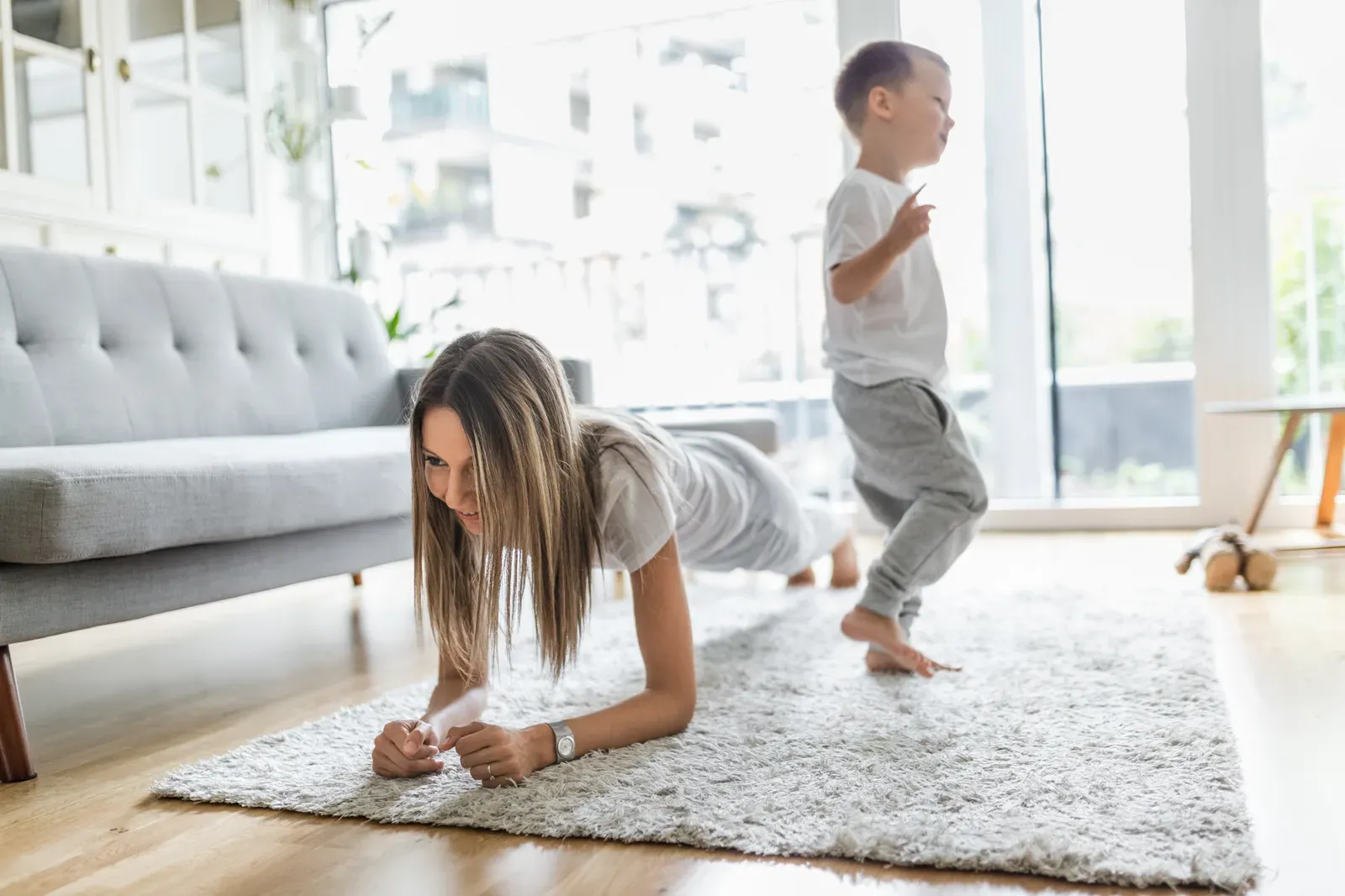 Mom and her son working out together in the living room, a home routine once the kids are in school