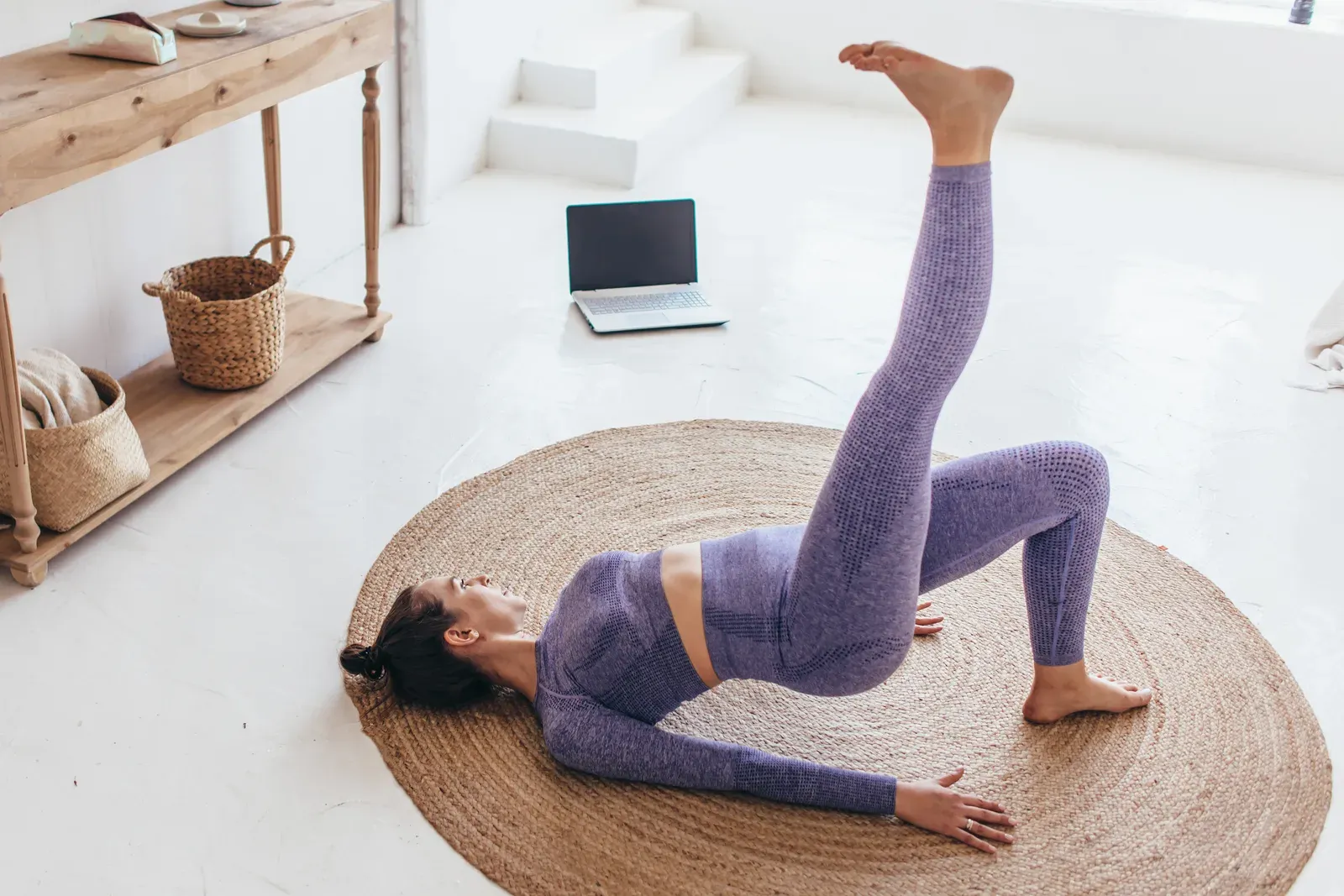 Fit woman at home doing a glute bridge, an easy exercise to return to after being sick