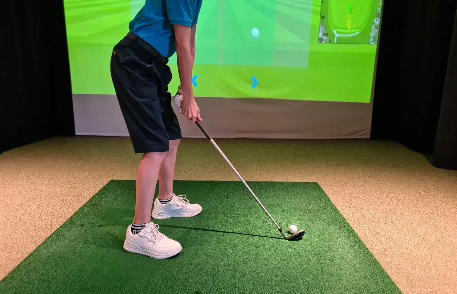A golfer working on rotational power with a trainer in a gym