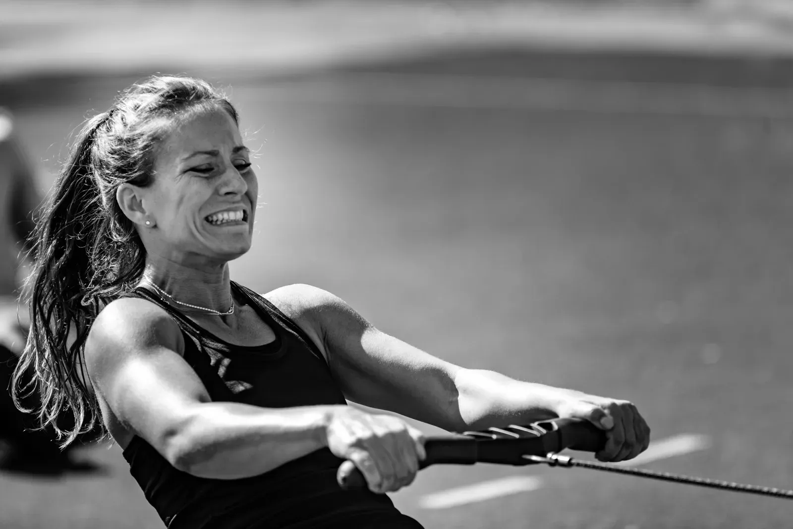 Person using a rowing machine, a common tool for both HIIT and steady state cardio