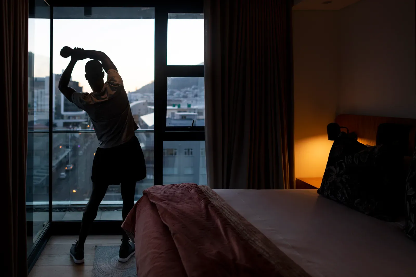 A business traveler lifting dumbbells in a small hotel gym