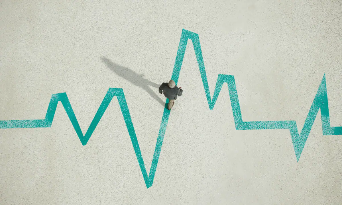 Man walking across a painted pulse trace, progress arriving step by step