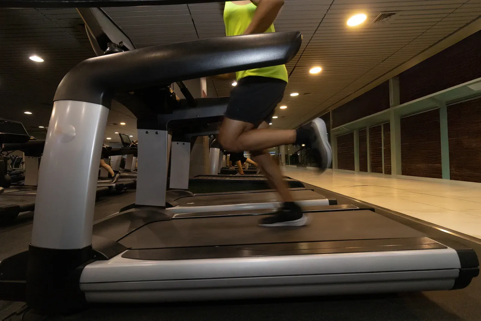 Runner's legs in motion on a treadmill during steady cardio training