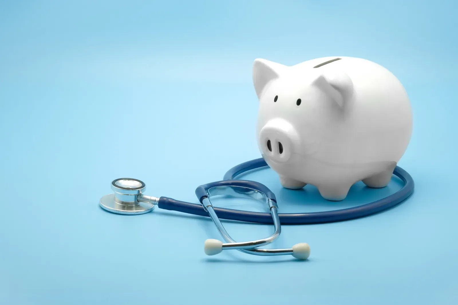 Piggy bank with a stethoscope, a nod to health savings accounts and medical costs