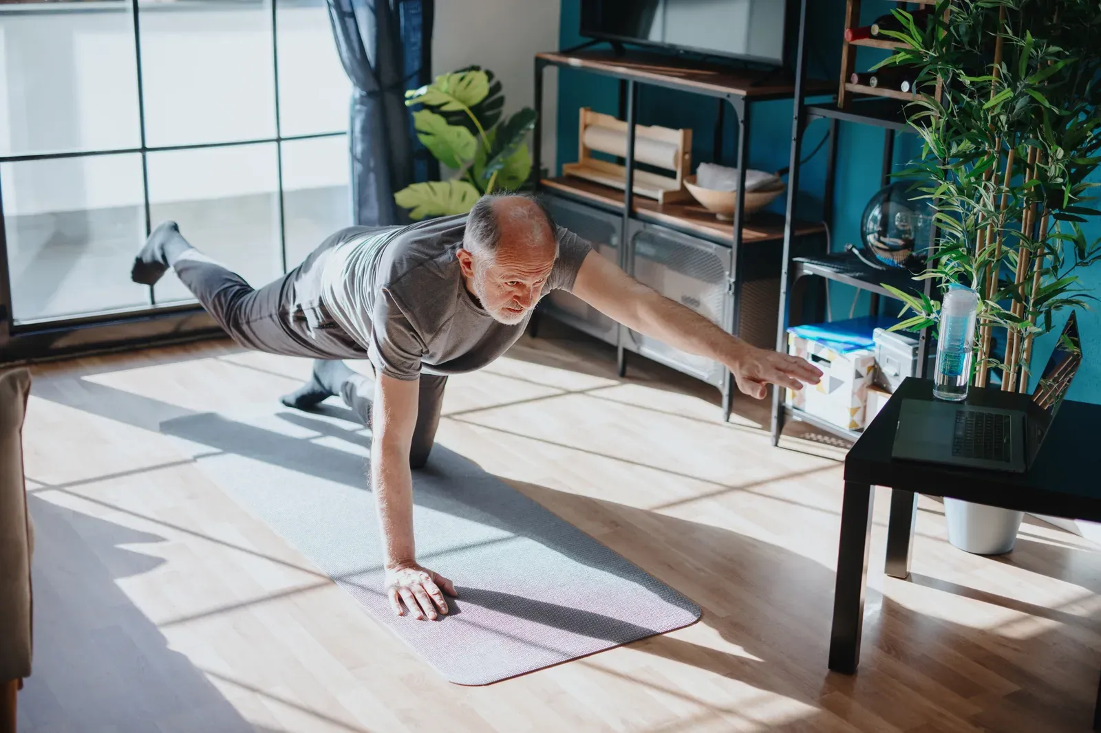 Senior man practicing a balance exercise during a training session