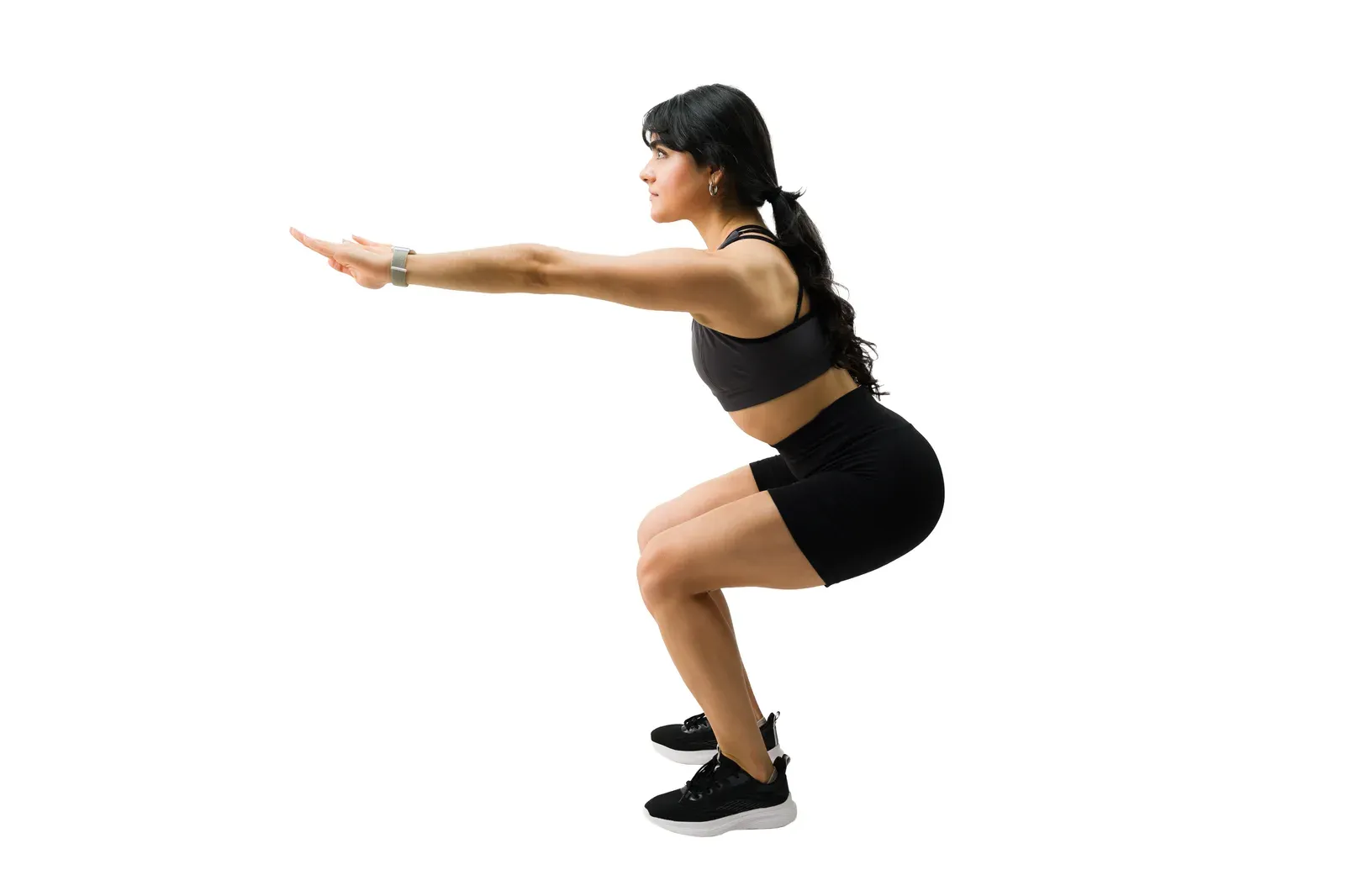 Young athletic woman doing squats for strength, a lift used to raise a low body composition score