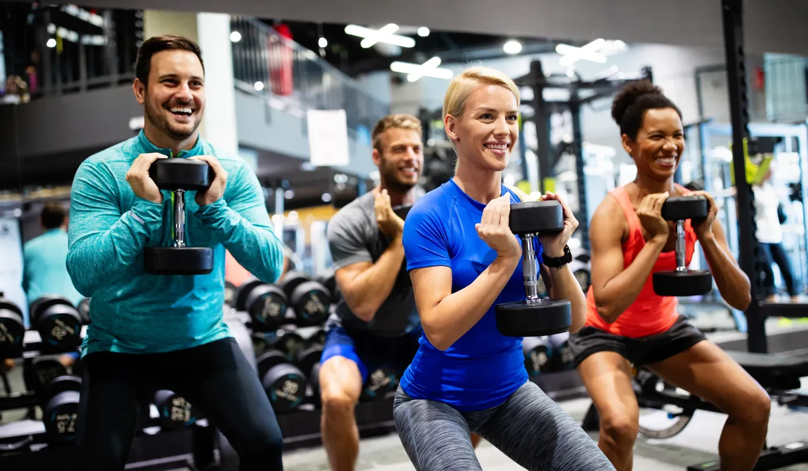 Group of young happy fit people doing exercises in a gym, an inclusive and welcoming training space