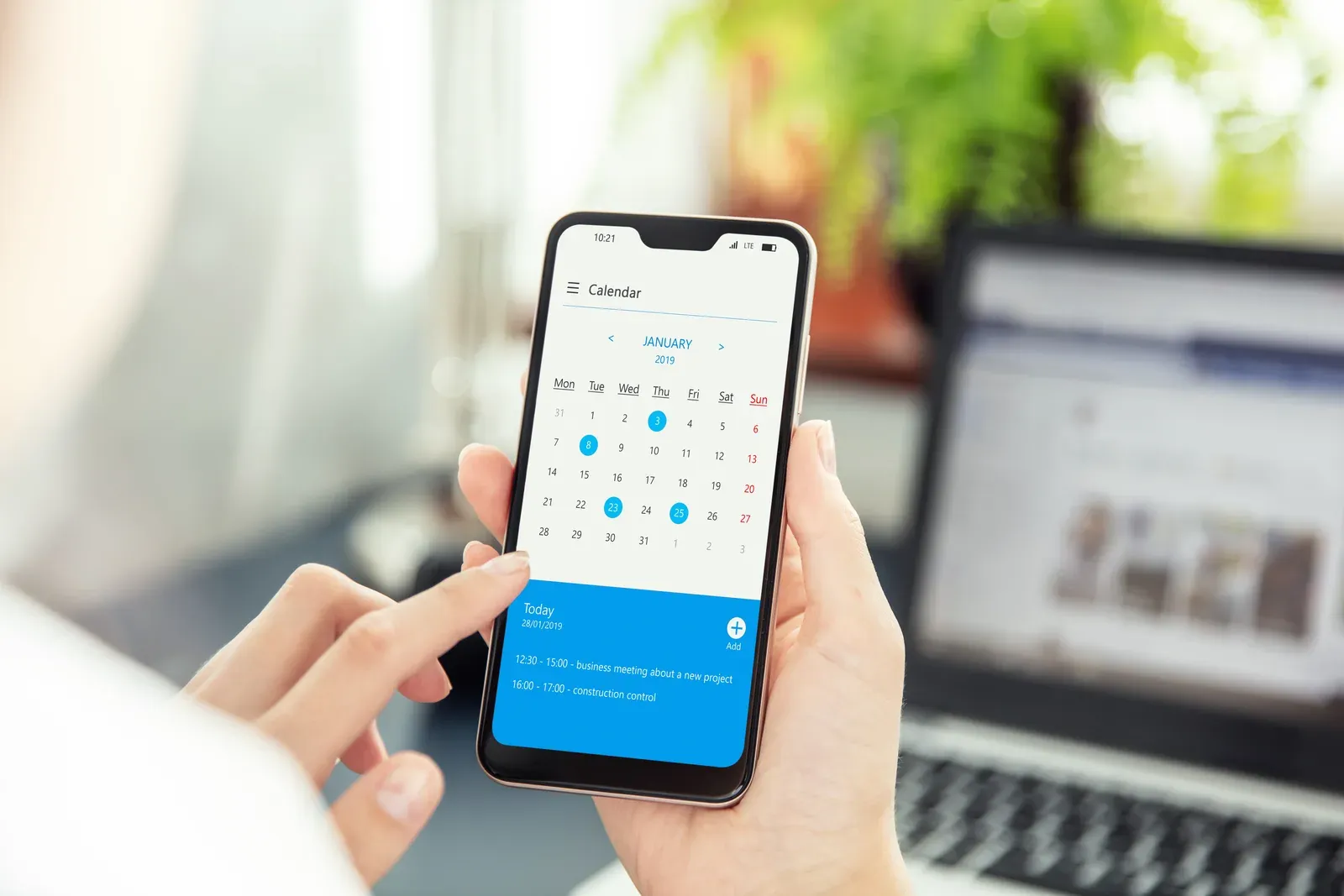 Checking a calendar app on a smartphone to reschedule a missed training week
