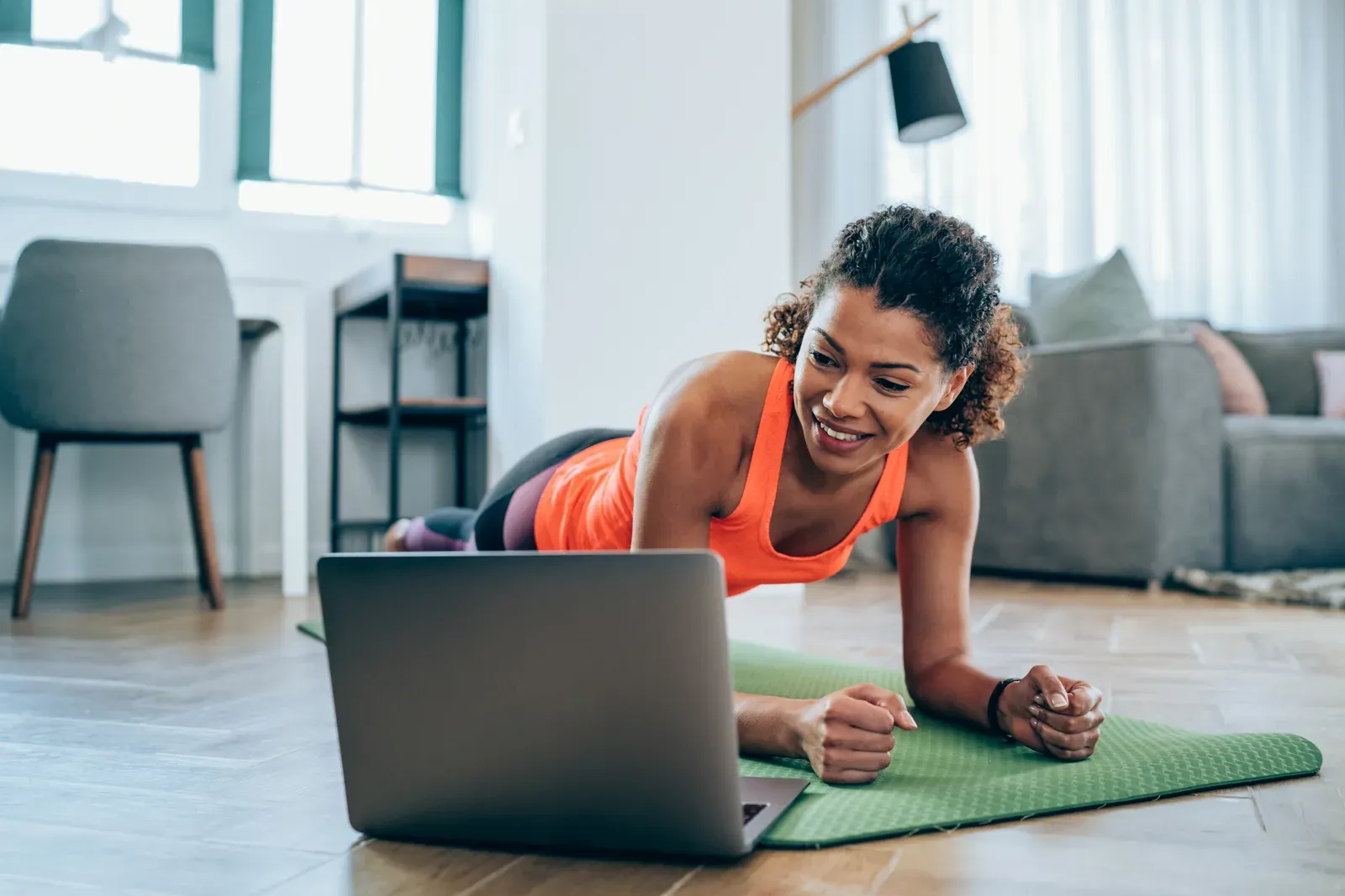 Home workout in progress as a woman trains without an in person coach