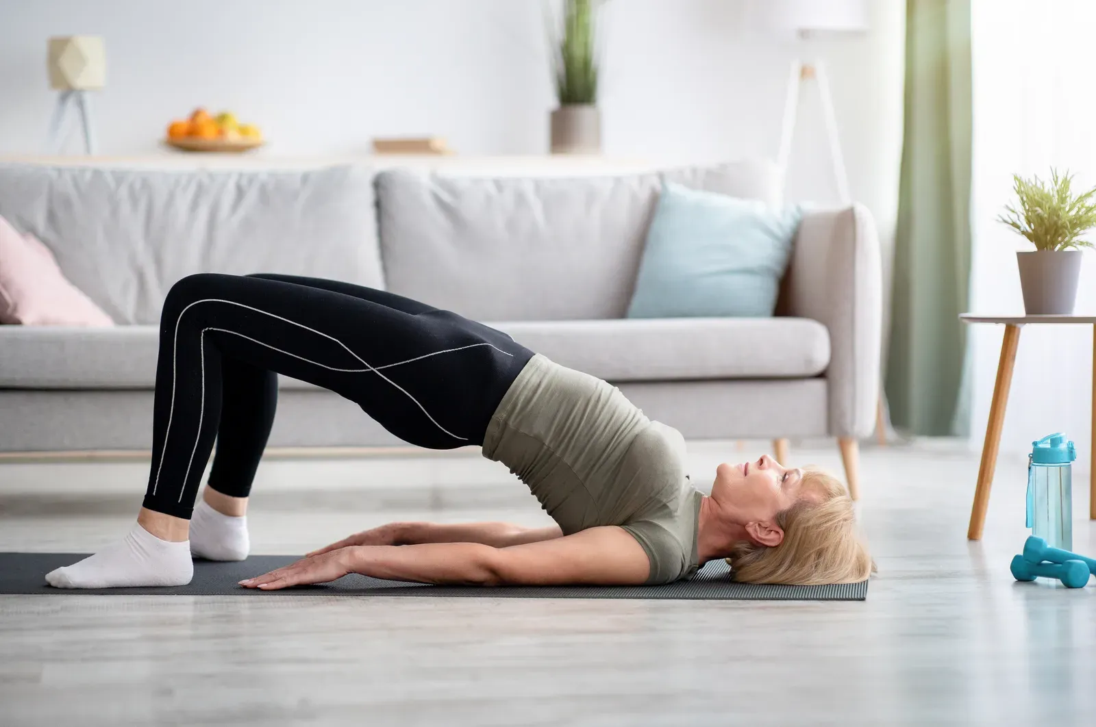 Woman performing a controlled cable pull-through exercise with focused breathing