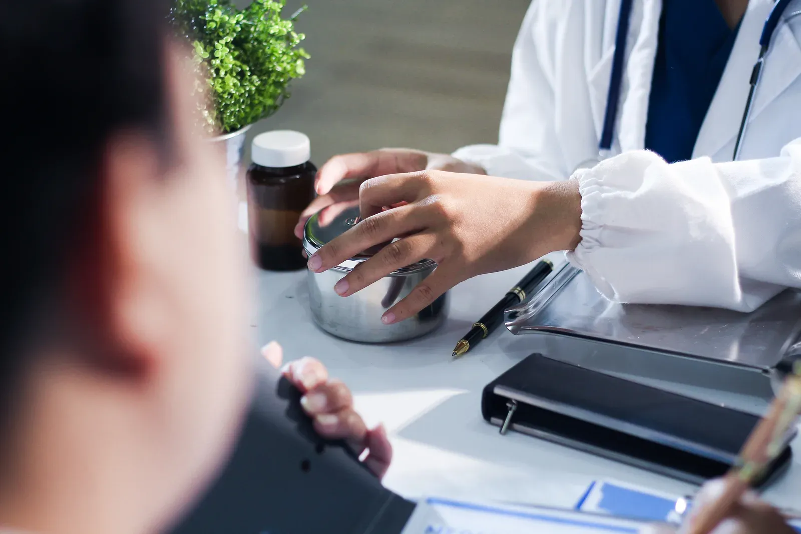 Medical team of doctors in white coats and scrubs in a meeting, professionals who work long shifts