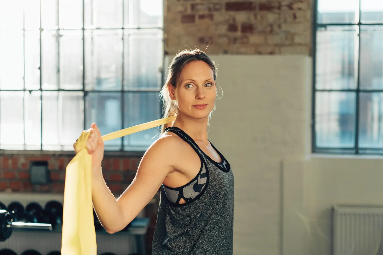Trainer adjusting a client's arm position during a neutral grip dumbbell press