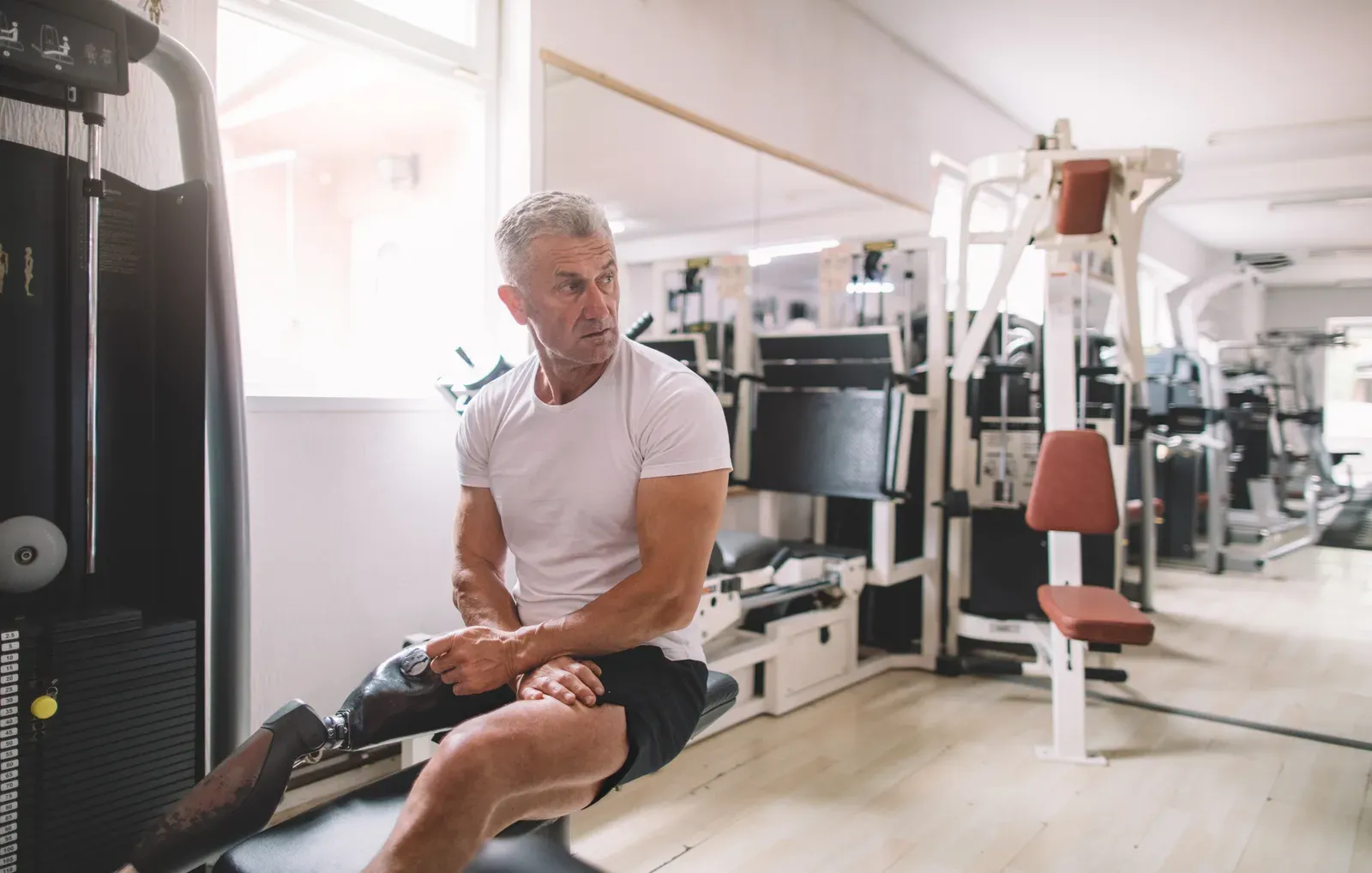 A focused man training with dumbbells in a private workout room