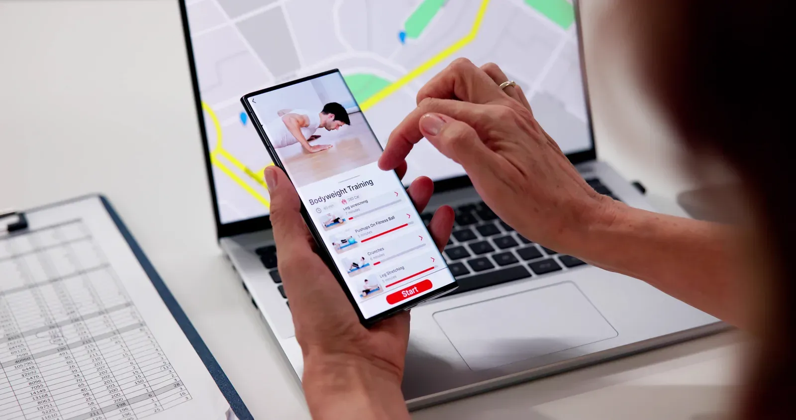 Person checking a map on a phone to compare nearby fitness options