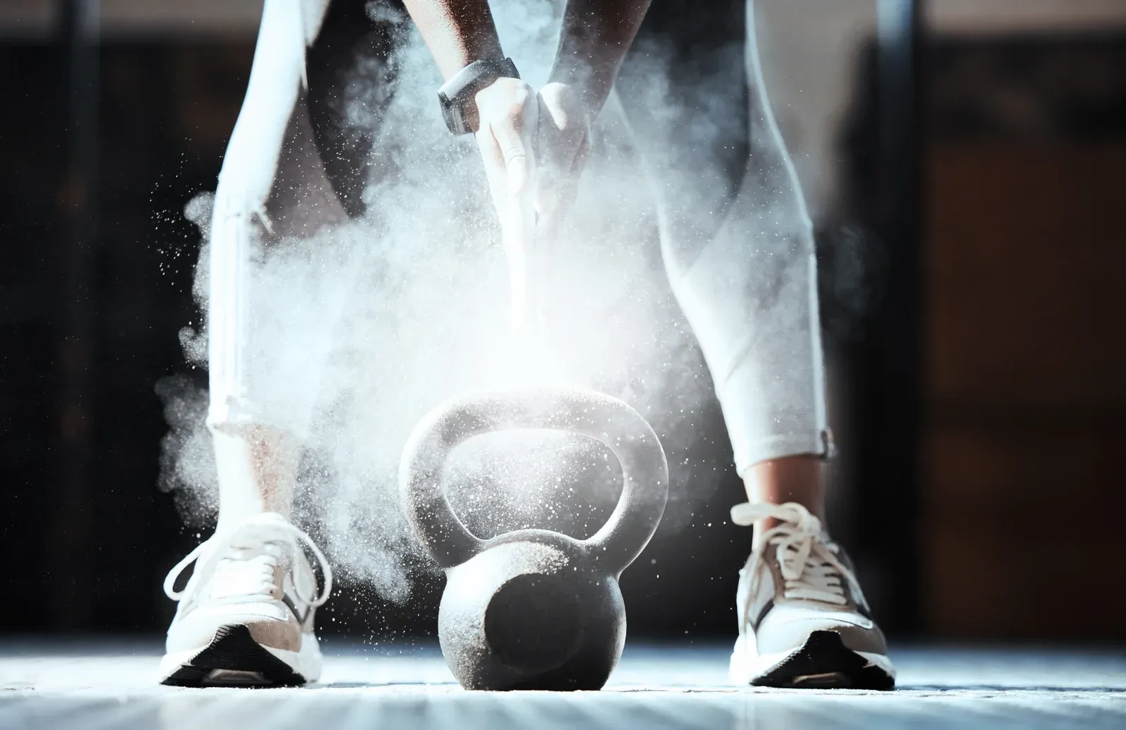 Cropped shot of a woman lifting a kettlebell at the gym, strength work behind a toned look