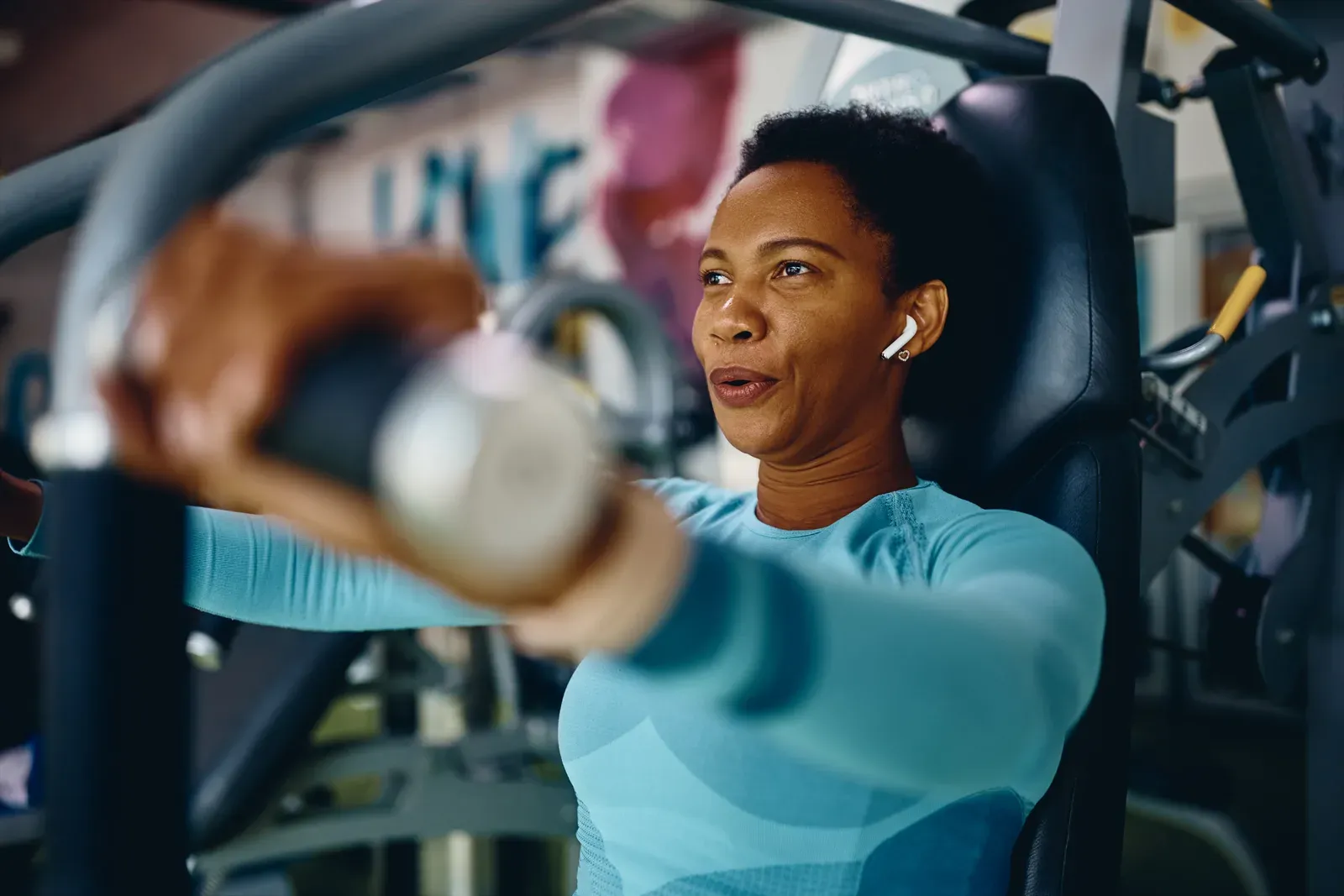 A middle aged woman taking a quiet moment for herself in a fitness studio