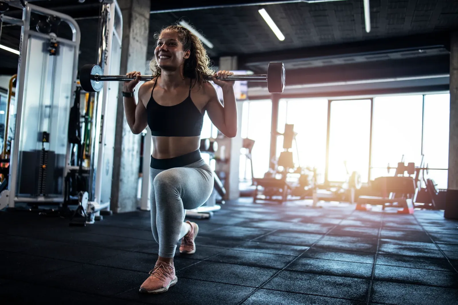 Woman exercising with weights in a fitness center, a session to plan around a GLP-1 medication
