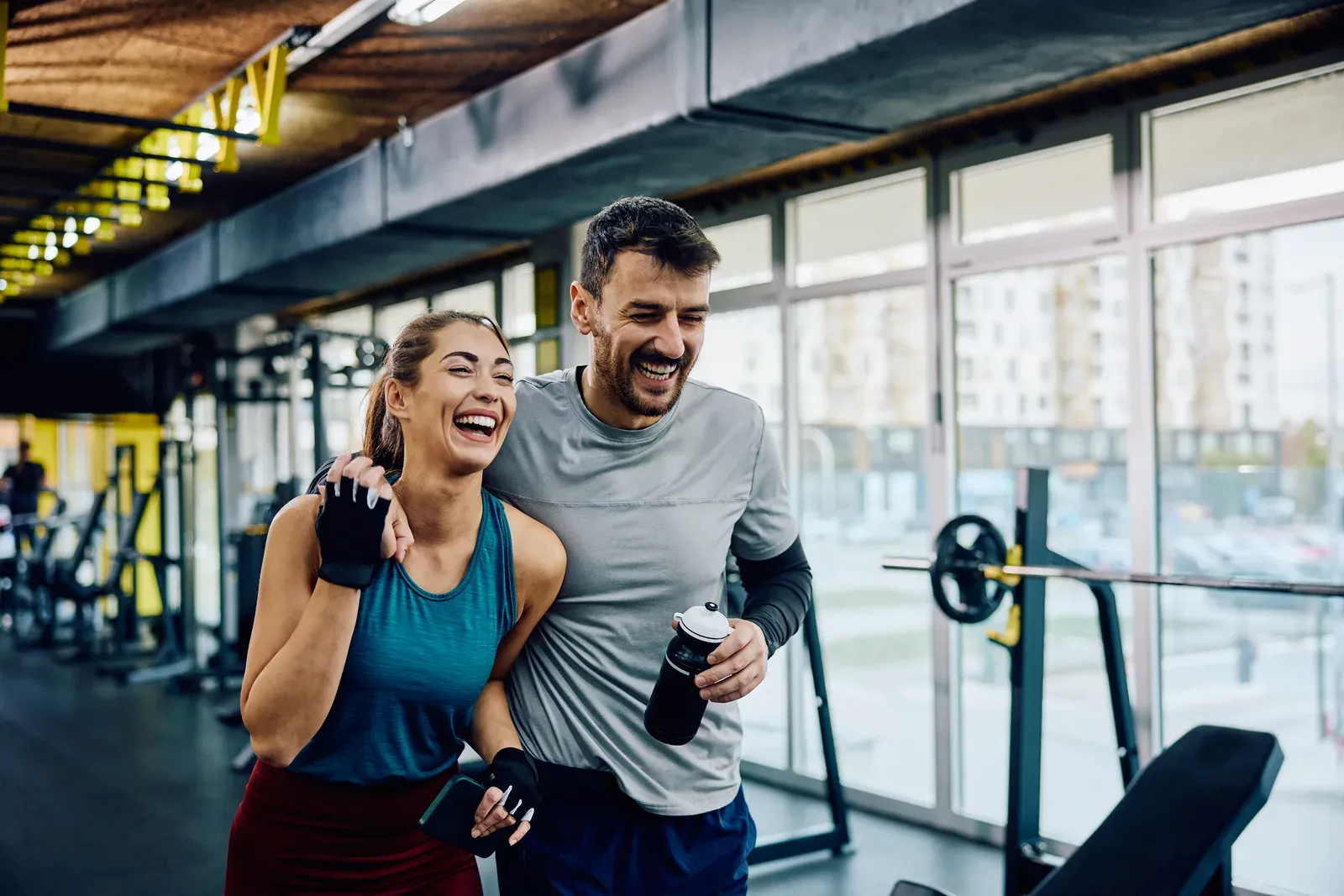 Trainer coaching two clients through alternating exercises in a small training studio