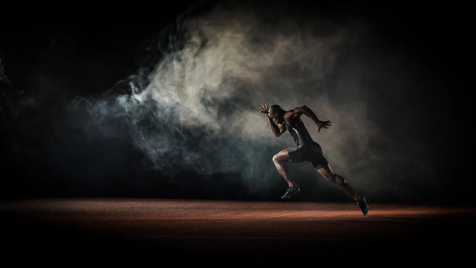 Distance runner in full stride, logging the miles that strength work protects