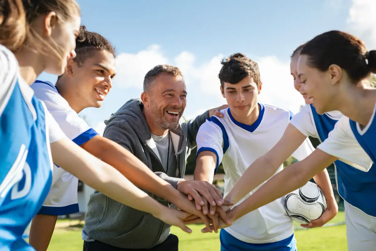 Teenage athlete listening closely to a coach during a training session