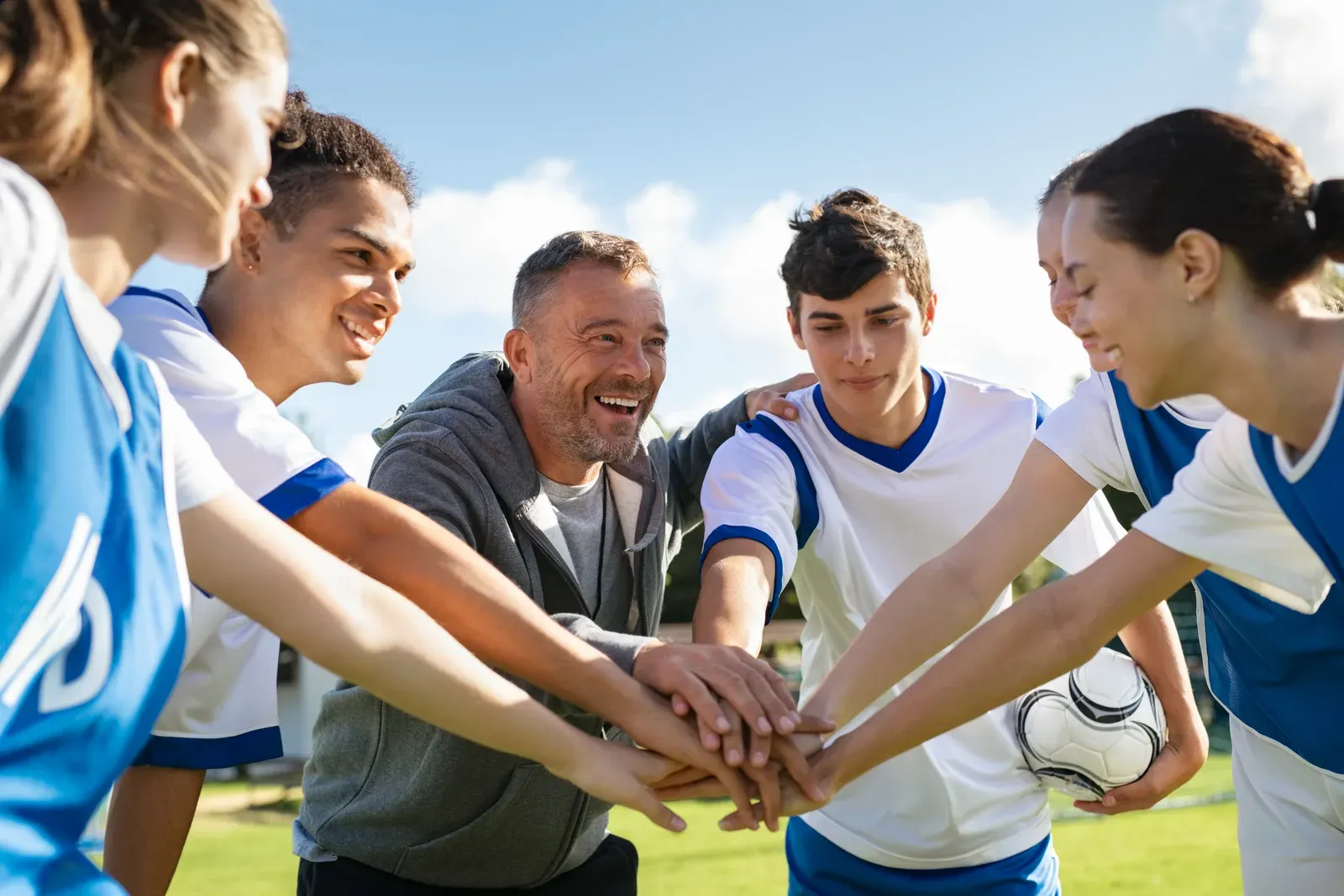Teenage athlete listening closely to a coach during a training session