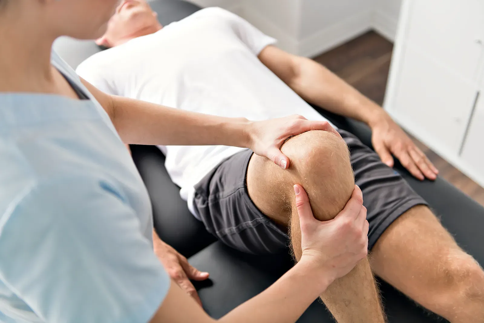 Physical therapist guiding a patient through rehab exercises at the clinic