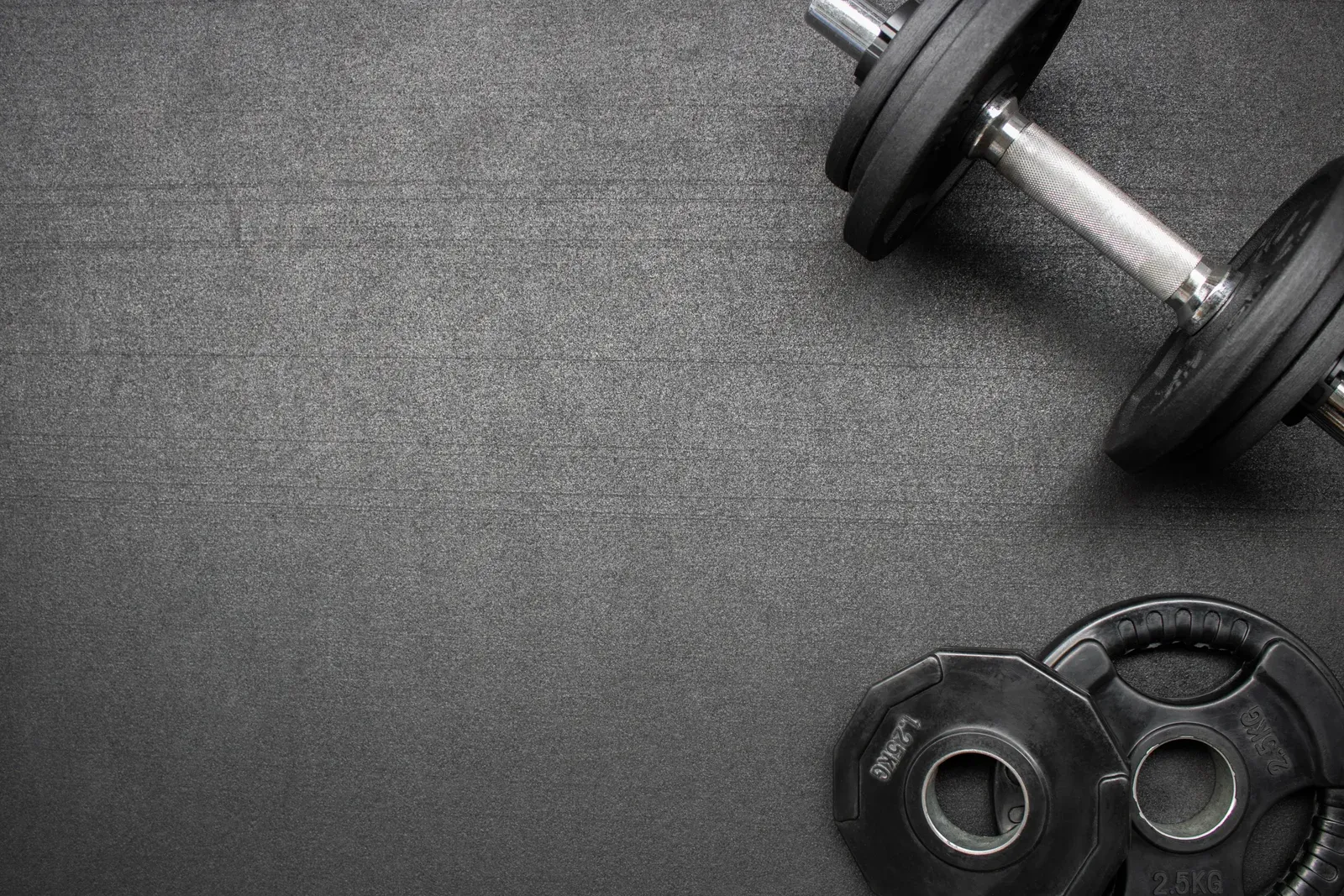 Fitness equipment laid out on the gym floor between sessions